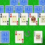 Yeşil bir zeminde, bir dizi açık ve kapalı iskambil kağıdı yer alıyor; ön planda kırmızı iki maçası ve joker kartı görünüyor